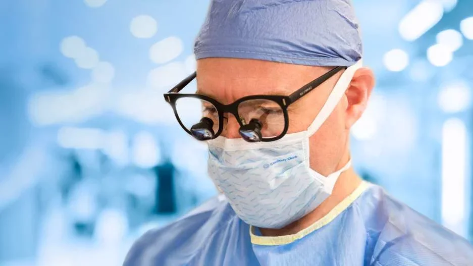 Close up of doctor in scrubs and glasses 