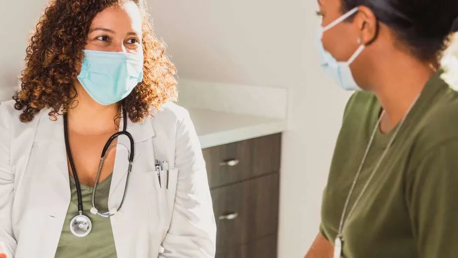 Dr and Patient interacting in a physician's room