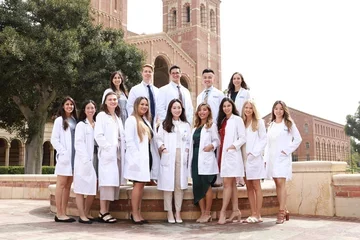 Advanced practice students in white coats