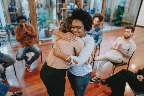 Young support group women hugging