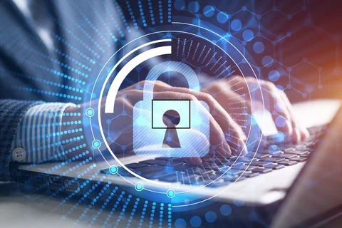 Lock superimposed over a person working on a laptop