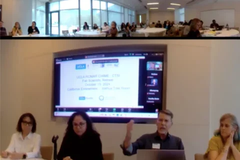 Group of five panelists giving presentation in front of a screen.