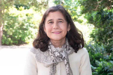 Dr. Yvonne Hernandez-Kapila standing in a garden