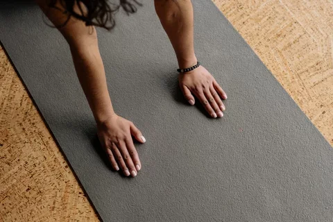 female hands touching a yoga mat
