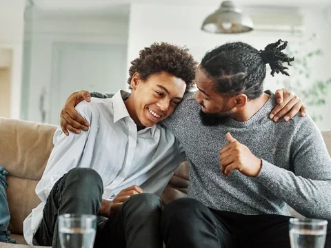 Father and son hug and smile