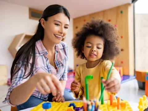 teacher and kid playing
