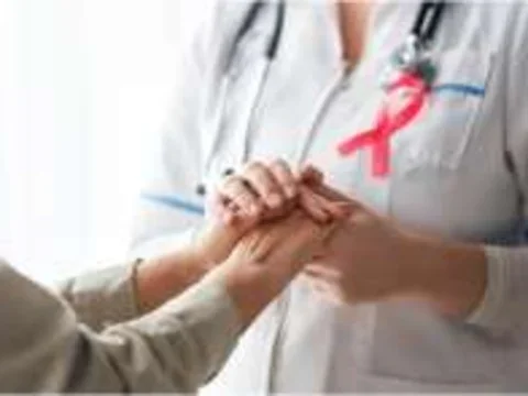 Doctor holding breast cancer patient's hand
