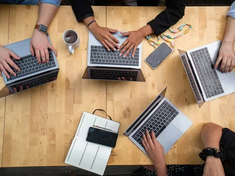 People working on laptops at a table