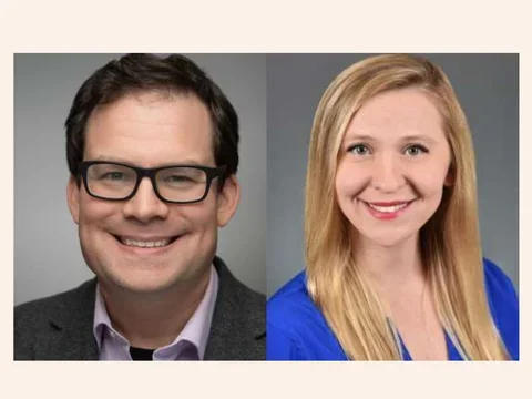 Man with glasses smiling and woman smiling