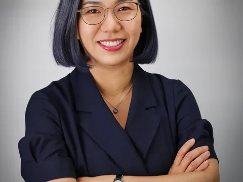Dr. Sarah Ko headshot, wearing glasses and dark collared shirt.
