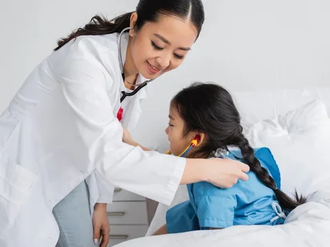Doctor examines pediatric patient with stethoscope
